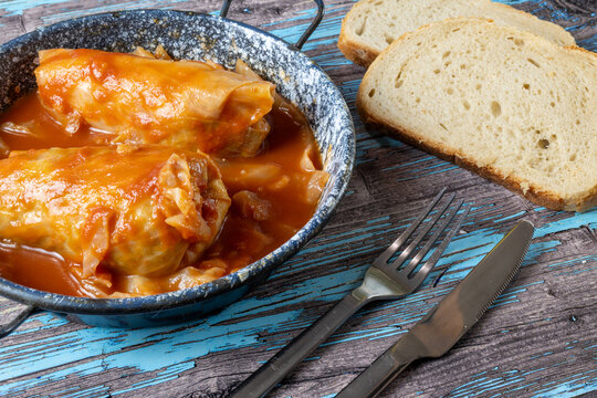 Traditional Hungarian stuffed cabbage rolls served in a rustic enamel dish with rich paprika-colored sauce