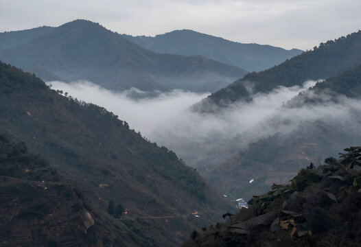 Mountain wilderness and nature conservation, misty valley with rolling hills and forest landscape in the morning light for travel and adventure tourism