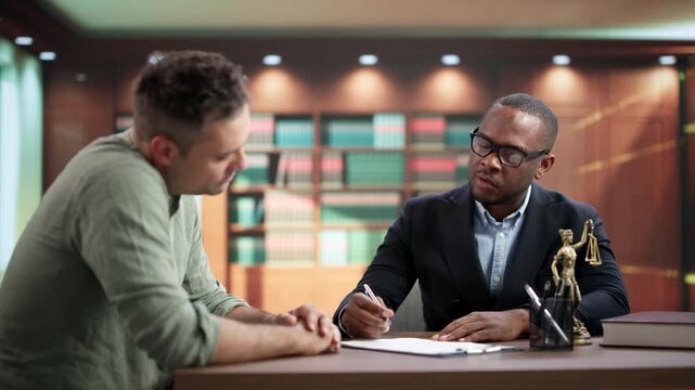 Young African Attorney Reviews Medical Malpractice Case With Client