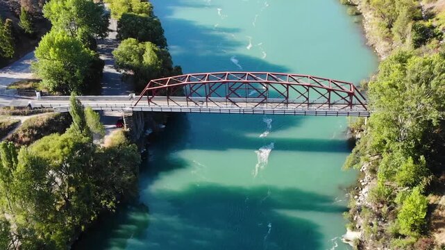 Bridge over Clutha River in Otago, New Zealand. Clyde town aerial reveal with Lake Dunstan.
