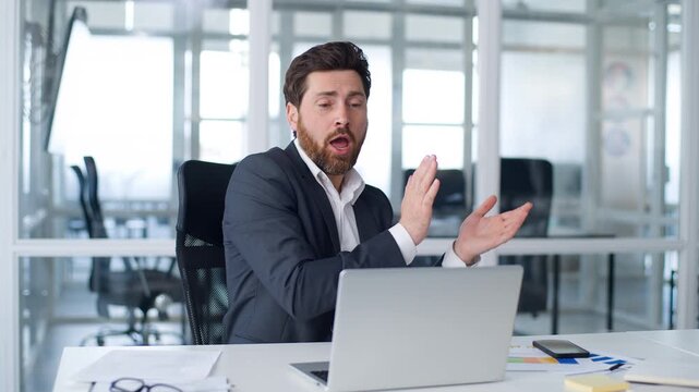 Caucasian middle-aged business man dancing listening music with laptop musical application spinning at chair at office mature European businessman male executive dance listen song at computer relaxing