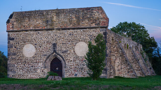 Historic stone ruins of Saint Procopius Church in Krupka, Czech Republic, photographed in soft evening light. The medieval mining church dates to the late 13th century
