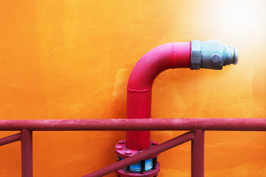 Red fire hydrant on the background of the wall. Place for text.