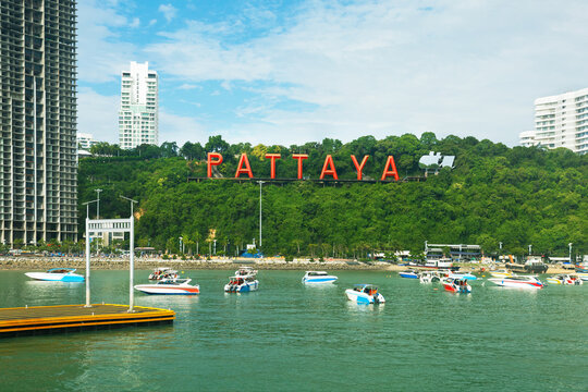 Pattaya City sign, hillside landmark featuring town name in capital letters.