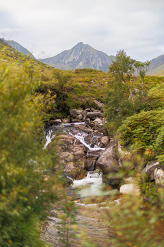 Rugged mountain looms behind a babbling stream in the Glen Rosa valley on Arran, Scotland