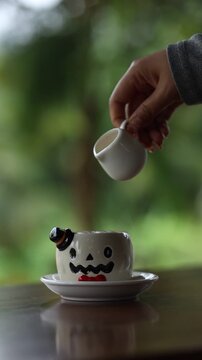 Creative Halloween Coffee with Ghost Shaped Cup and Milk Pouring