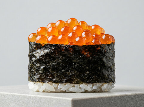 A single piece of delicious salmon roe sushi gunkan wrapped in seaweed.