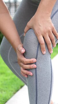 Runner touching painful twisted or broken. Athlete training, running up and down stairs accident. Sport sprained sprain cause injury knee. and pain with leg bones.