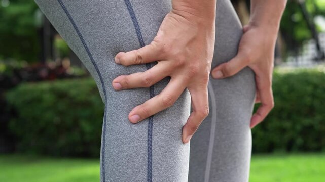 Women while exercising touching painful twisted or broken. Athlete training, running up and down stairs accident. Sport sprained sprain cause injury knee. and pain with leg bones.