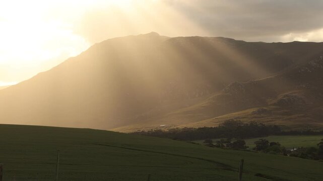 beautiful sunset light falling upon Klein Mountains and farmland, Stanford, South Africa