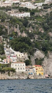 View of Conca dei Marini village with colorful houses on the rocky cliffs, Amalfi Coast, Campania, Italy