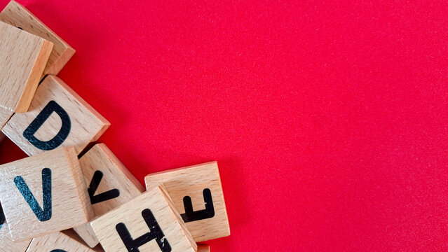 Messy Scrabble wooden tiles on red background