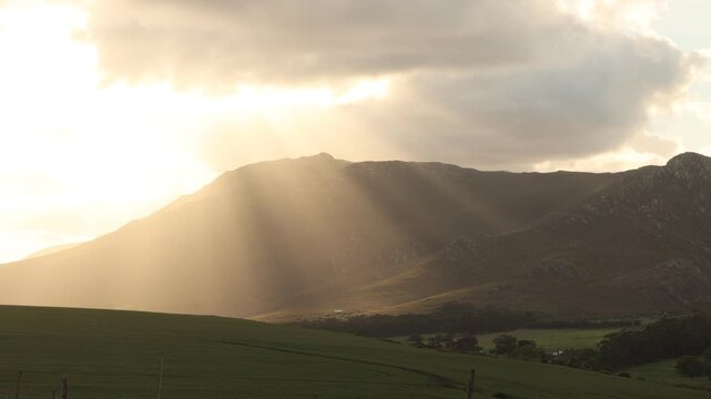 beautiful sunset light falling upon Klein Mountains and farmland, Stanford, South Africa