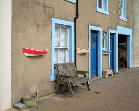 Traditional stone house with wall-mounted boats near Pittenweem Harbour in Scotland's East Neuk of Fife