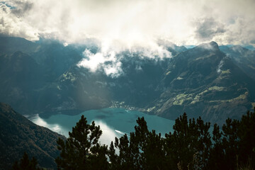 Clouds drifting over a turquoise alpine lake in the Swiss Alps © itsbyparham