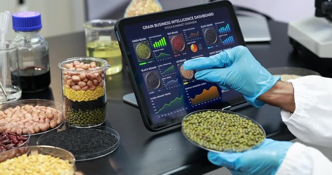 Scientist in blue gloves examines a dish of mung beans beside mixed grain samples and a tablet crop data in a modern food research laboratory.