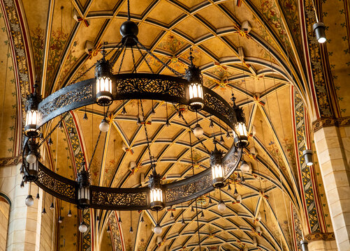 Ornate gothic vaulted ceiling with chandelier and warm lanterns