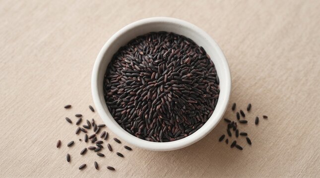 Black Rice Grains in Ceramic Bowl, premium whole grain ingredient with minimalist presentation for healthy food and nutrition concepts