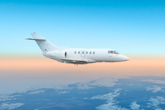 White bizjet fly in the air above the clouds