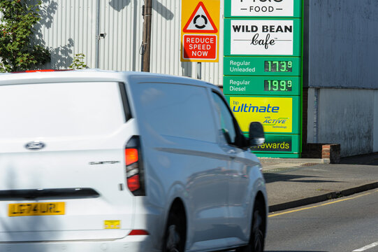 White Van Drives Past BP Sign Showing High Diesel Prices at &pound;1.99