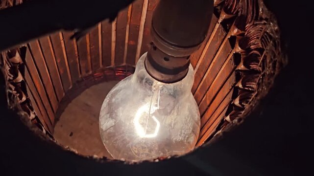 Close up texture of copper motor windings illuminated by a bright lamp, highlighting the intricate geometry of industrial machinery components and the gritty reality of mechanical repair work.