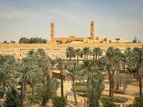 A towered building overlooks a dense palm grove in the Diriyah oasis, Riyadh, Riyadh, Saudi Arabia