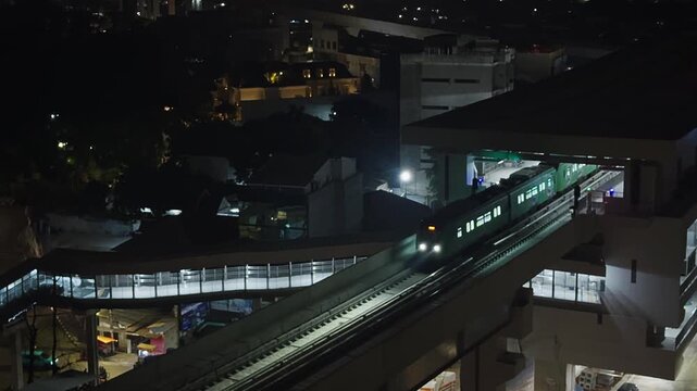 Jakarta LRT train departing from the station at night.