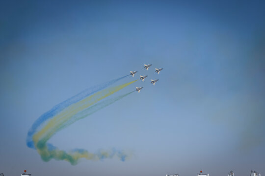 Six aerobatic jets trail colored smoke across a clear sky, Riyadh, Riyadh, Saudi Arabia