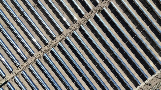 close up view of parabolic trough solar thermal power plant mirrors