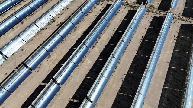 rows of parabolic trough solar thermal power plant in desert