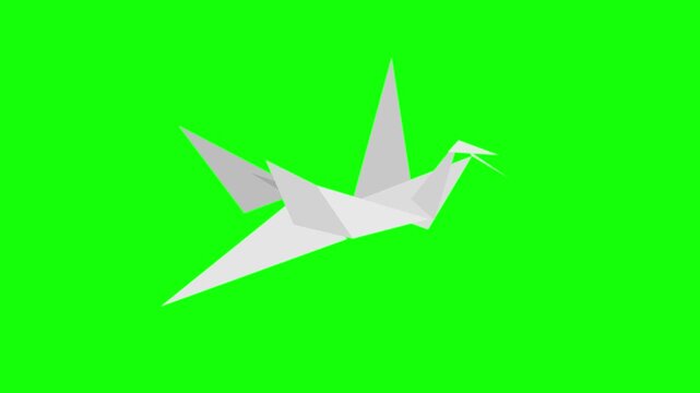 White origami cranes arranged in grid on green screen