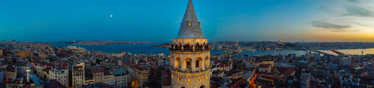 Panoramic aerial view of Galata Tower and Golden Horn at twilight blue hour Istanbul