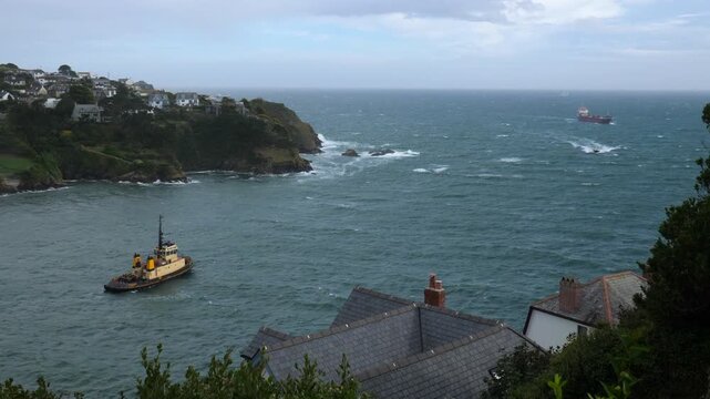 China Clay ship at sea approaching Fowey Harbour. Fowey is an important export port for China Clay (kaolin) mined in Cornwall, UK. This unladen ship is approaching Fowey harbour