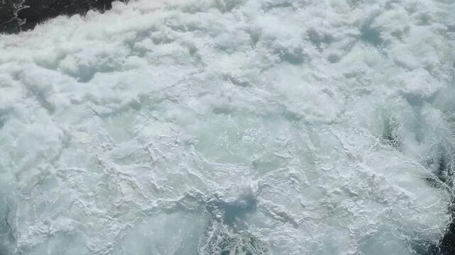 Ocean surf spreading across dark water