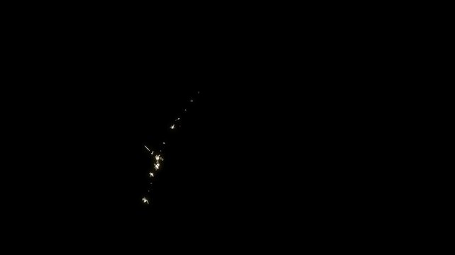 Twinkling cartoon white stars in doodle vector style sparkle over golden glitter dust trail, magic light particle animation 4K with alpha channel on black screen glowing fantasy background.