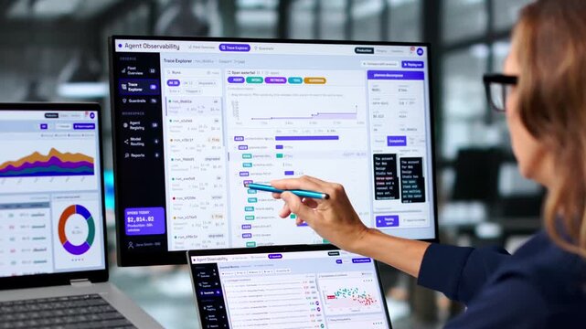 Software Engineer Carefully Monitors AI Workflow On Laptop