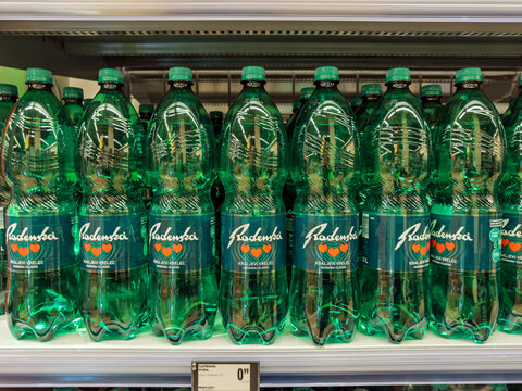 Lubiana, Slovenia- September 9, 2026:  Row of green Radenska sparkling mineral water bottles displayed on supermarket shelf with price tag, Slovenian brand with heart logo