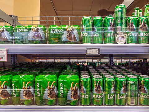 Lubiana, Slovenia- September 9, 2026:  Multiple shelves stocked with Lasko Zlatorog beer cans and multipack bottles featuring mountain goat logo, popular Slovenian brand