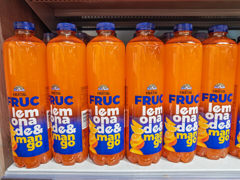 Lubiana, Slovenia- September 9, 2026:  Row of Fructal lemonade and mango flavored orange drink bottles displayed on supermarket shelf, Slovenian juice brand since 1945