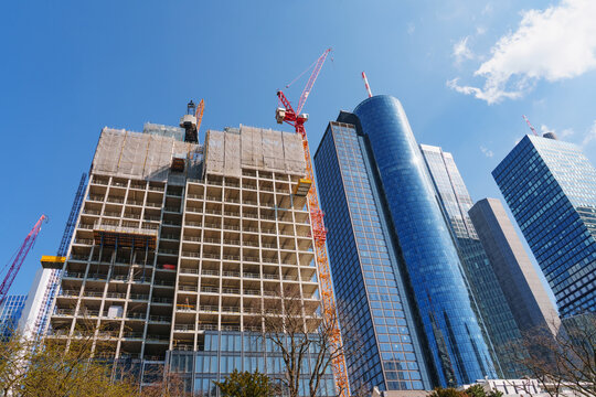 A busy construction site in an urban setting - erecting a large skyscraper. No AI.