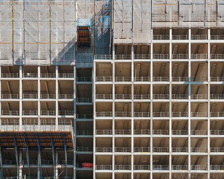 A busy construction site in an urban setting - erecting a large skyscraper. No AI.