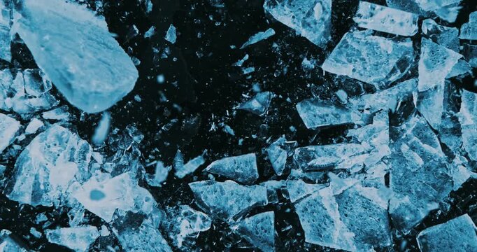 Super slow motion of falling piece of ice on black background. Filmed on high speed cinema camera, 1000 fps.
