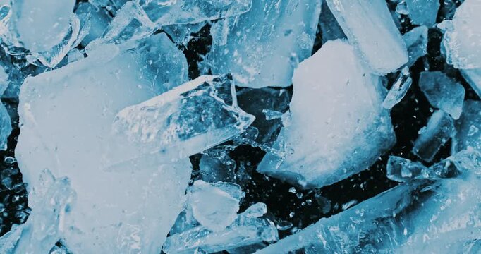 Super slow motion of falling piece of ice on black background. Filmed on high speed cinema camera, 1000 fps.