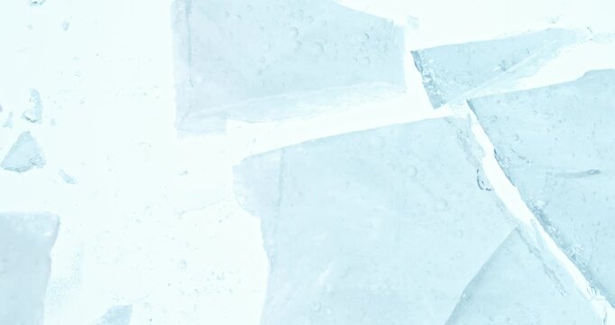 Super slow motion of falling crashed ice into white background. Filmed on high speed cinema camera, 1000 fps.