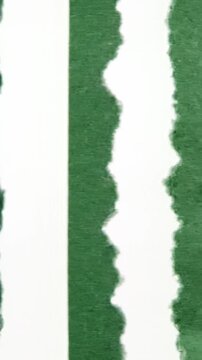 Hanging torn green paper with subtle variations in textures and shapes over time