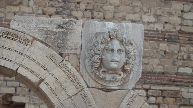 Close-up Gorgon head carving at Leptis Magna ruins in Libya