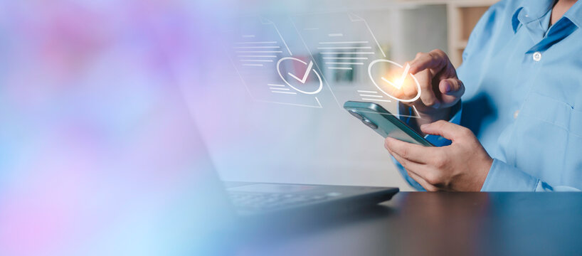 Concept of digital signature, audit, online contract approval, mobile business management and financial tech compliance Businessman hands holding smartphone with floating verified document icons.