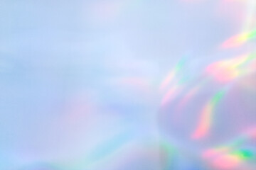 Abstract pastel blue background with soft holographic gradient and prismatic light leak. Aesthetic minimal overlay texture for banner and modern design. © IULIIA