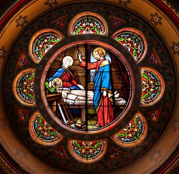 Nativity stained glass rose window within an arch