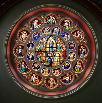 Stained glass rose window framed by an interior wall